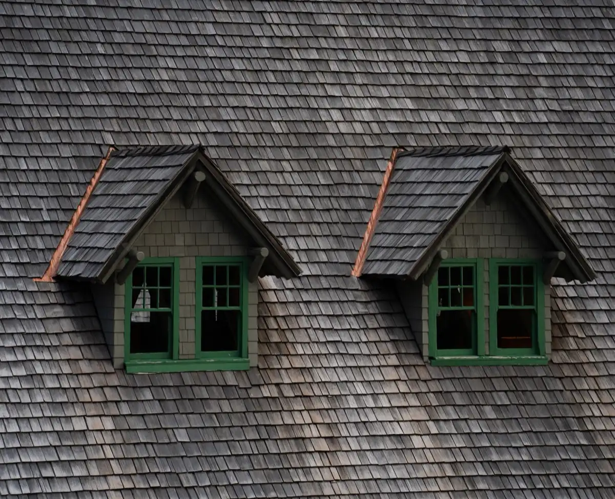 Dormers on a shingle roof in Fontana, CA, where step flashing and kickout flashing carry water past the walls